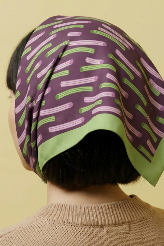 Churros bandana wrapped on head, purple fabric with green and pink striped pattern