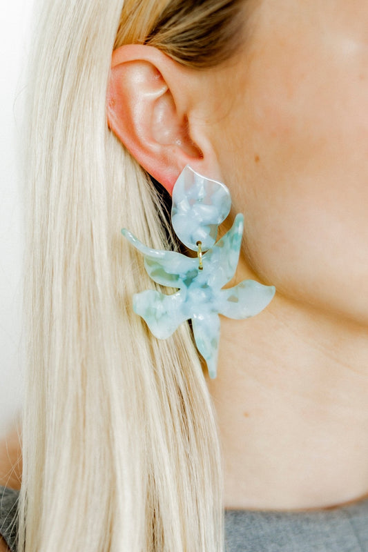 Mint floral statement earrings viewed on the ear, with gold-tone hooks