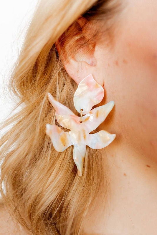 Iridescent layered-flower statement earrings with gold-tone hoops, pastel pink accents