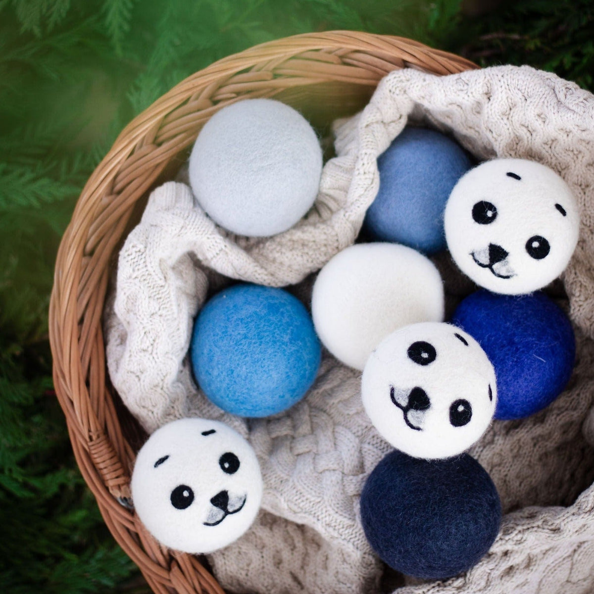 Wicker basket with panda plush balls and blue and gray felt balls