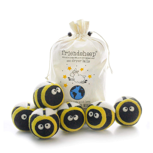 Plush bee dryer balls set in a drawstring bag, yellow-and-black striped with smiling faces