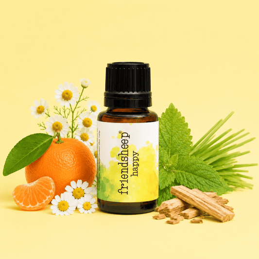 Happy essential oil blend bottle with orange, flowers, green leaves, and wood pieces