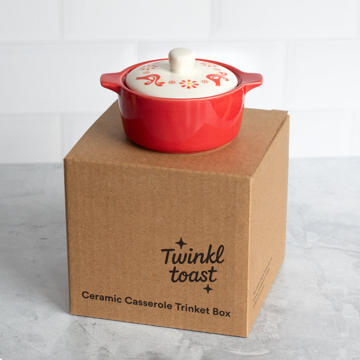 Ceramic casserole trinket box on brown gift box packaging with printed Twinkled toast text.