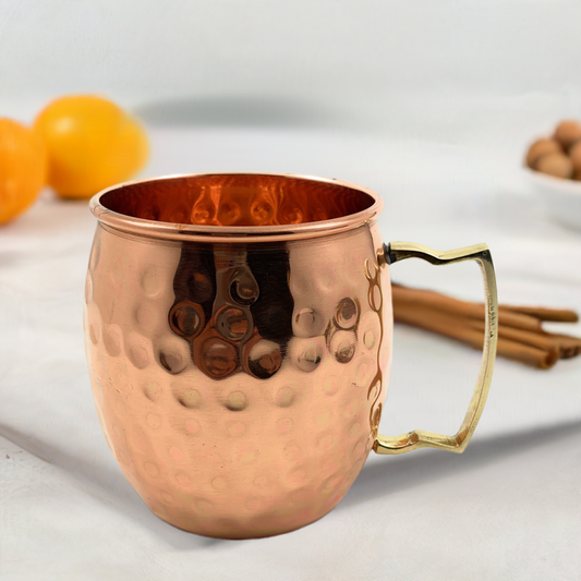 Hammered copper Moscow mule mug with brass handle, front 3/4 view
