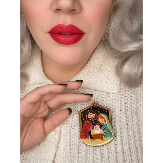 Gold-tone Nativity brooch with Mary, Joseph, and baby on sweater
