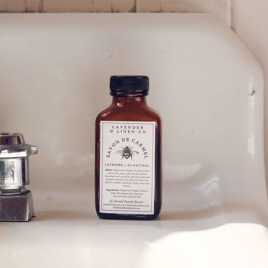 Lavender bath salts bottle in amber glass with dark cap and cream label