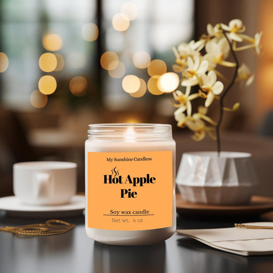 Amber glass jar candle with lit wick and orange label, on a dining table.