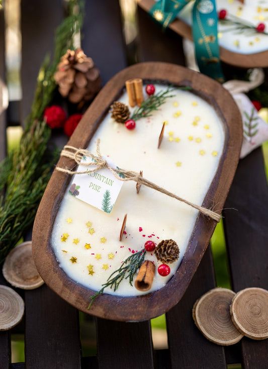 Handcrafted wooden dough bowl candle with herbs and gold star sprinkles, tied tag
