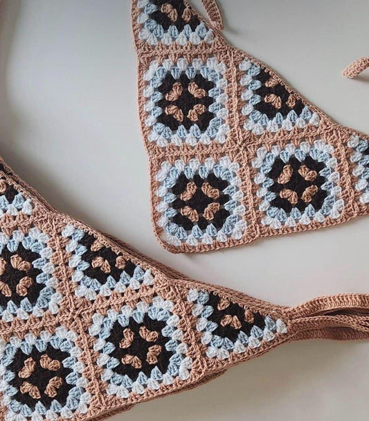 Crochet bandana with brown, light blue, and black granny square panels and ties