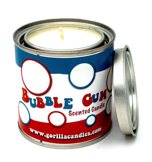Scented candle in metal tin with blue-red label and visible flame