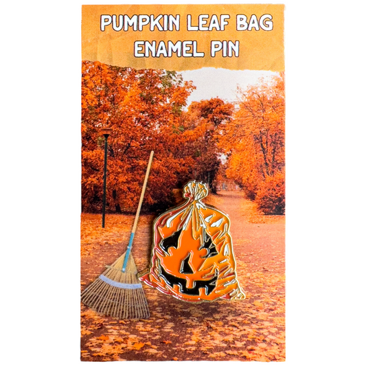 Enamel jack-o'-lantern leaf bag pin in orange with black cutout and gold outlines