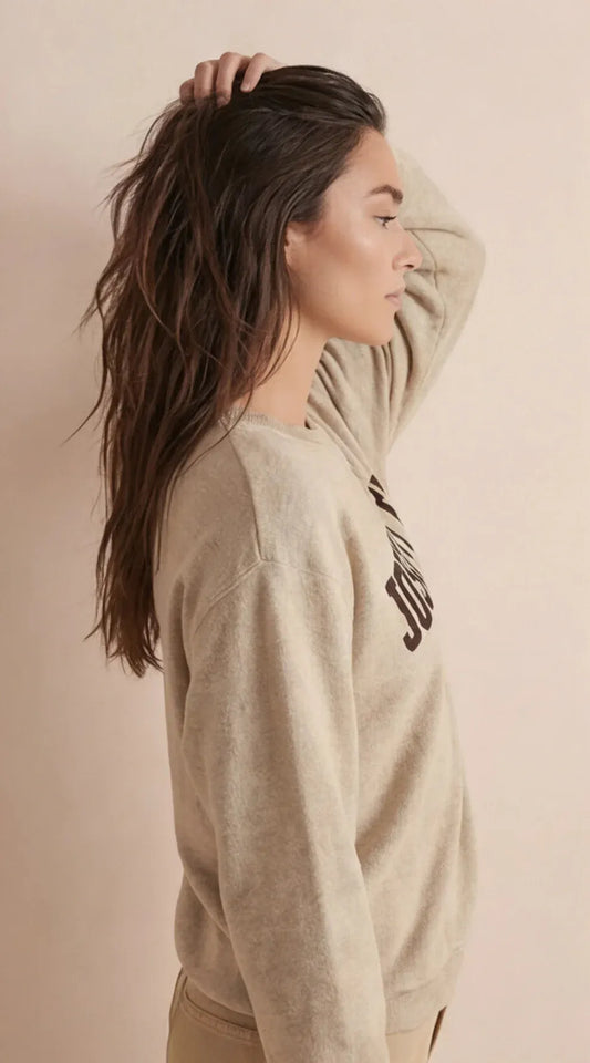Beige sweatshirt, side view with crew neck and partial Joshua Tree graphic on sleeve