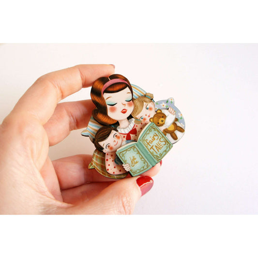Laliblue Mother's Day brooch held in hand, illustrated mother with two children