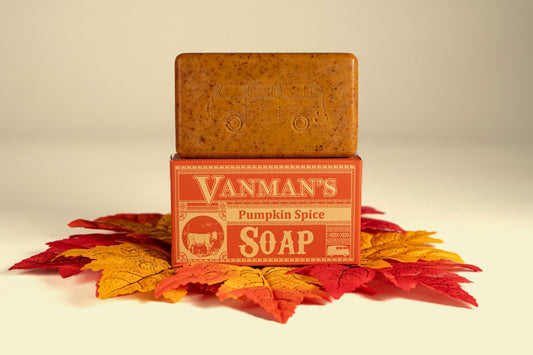 VanMan's Pumpkin Spice soap with stacked bar and orange box beside fall leaves