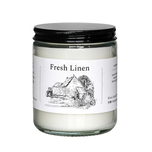 Fresh Linen jar candle in clear glass with black lid and illustrated label