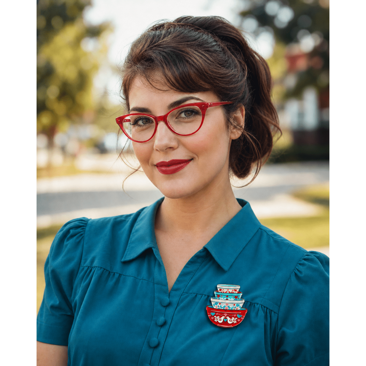 Nesting bowls heart brooch on teal shirt, red-and-white bird design