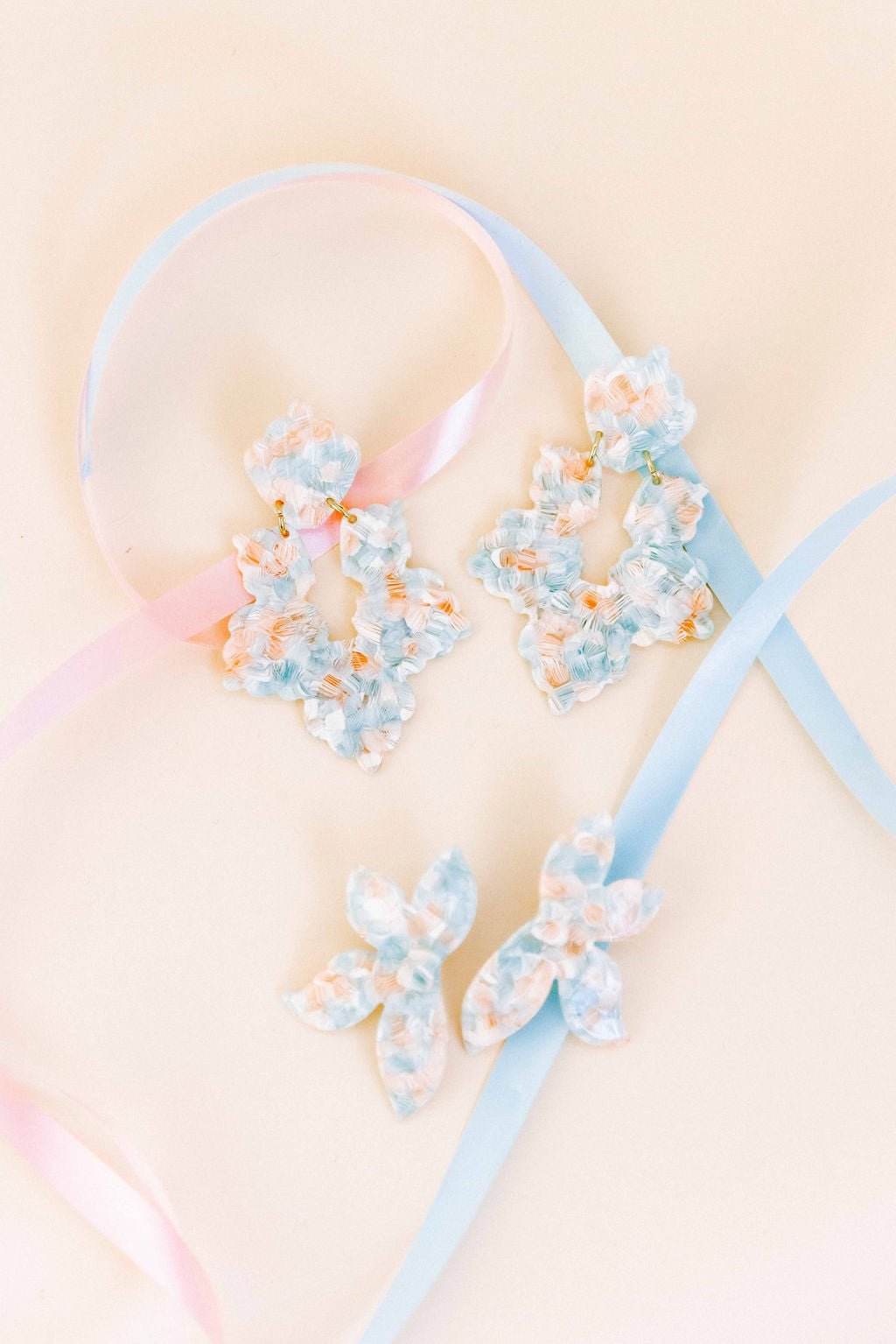 Mint shell earrings featuring multiple layered floral pieces in light blue, peach accents