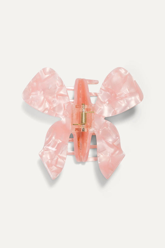 Pink translucent bow hair claw with center hinge, flat front view