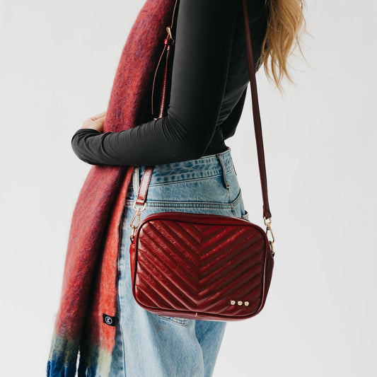 Draped red ombre scarf over shoulder, blue and cream gradient with fringe