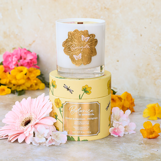Stacked Petitgrain Botanica candles: white jar on top, yellow jar below