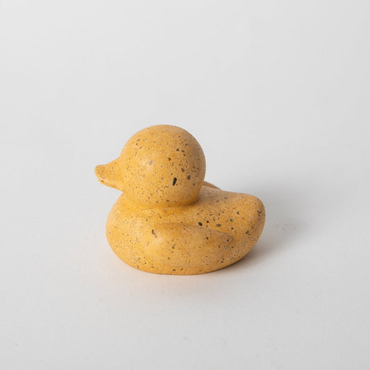 Marigold mini rubber duck figurine, speckled yellow, facing left