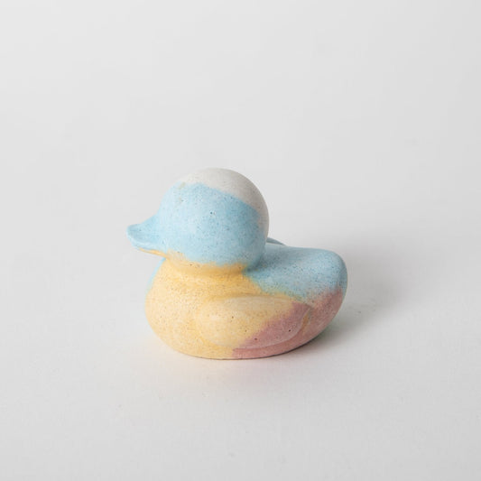 Mini rubber duck figure, speckled blue-and-yellow body with rounded back