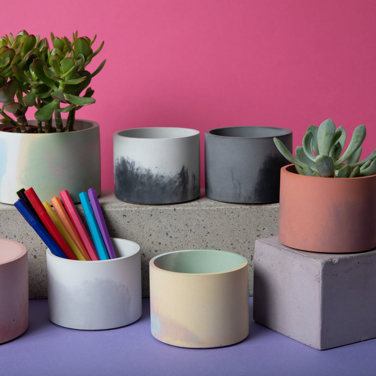 Ceramic round planter with pastel gradient glaze, mint and pink tones, empty.