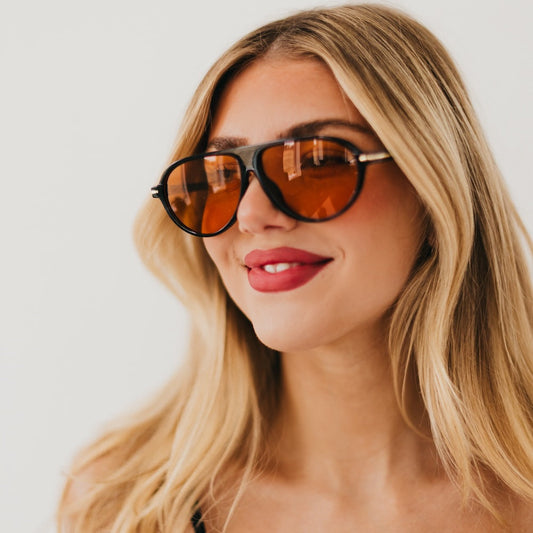 Oval sunglasses with tortoise frame and amber-tinted lenses