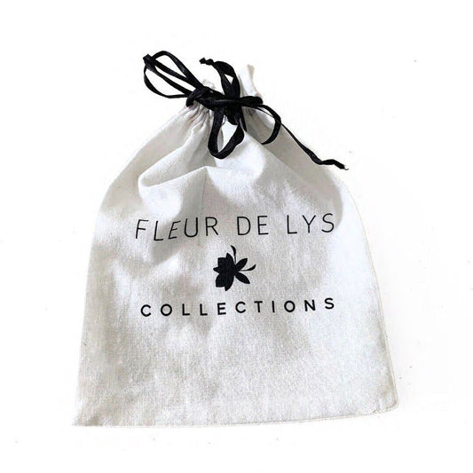 White fabric pouch with black drawstring and logo, containing hair clips set