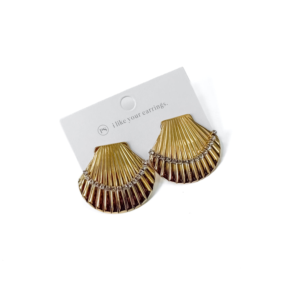 Pair of gold shell hoop earrings on display card, ridged fan design