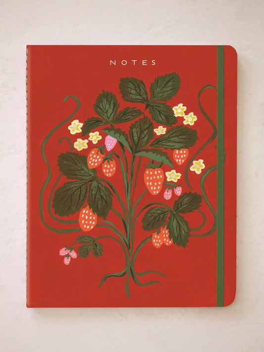 Red botanical NOTES notebook with stitched cover and strawberry-like flowers.