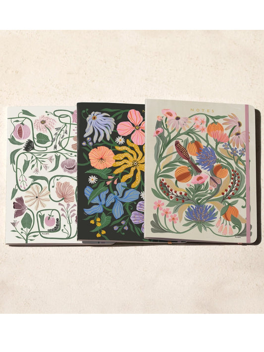 Trio notebook set with three stitched floral covers: white, dark, and light pink palettes