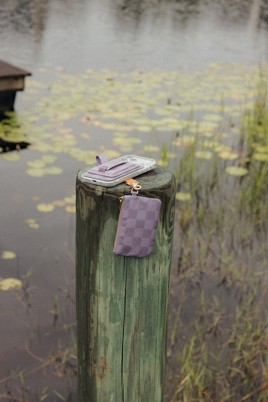 Small purple checkered zipper pouch with strap, hanging from a ring