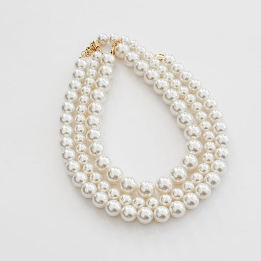 Chunky pearl three-row necklace, white round pearls with gold-tone end hardware