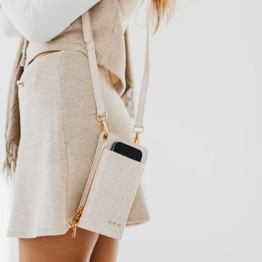 Woven double-duty phone bag with light cream textured front and gold chain strap