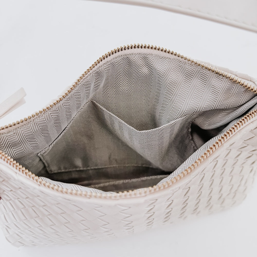 Cream woven hobo bag interior with gray lining and top zipper trim