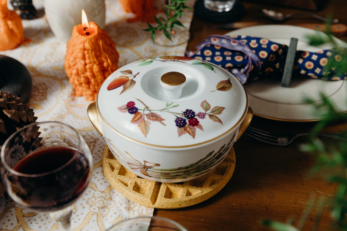 Marigold terrazzo waffle trivet beneath a white floral teapot with lid