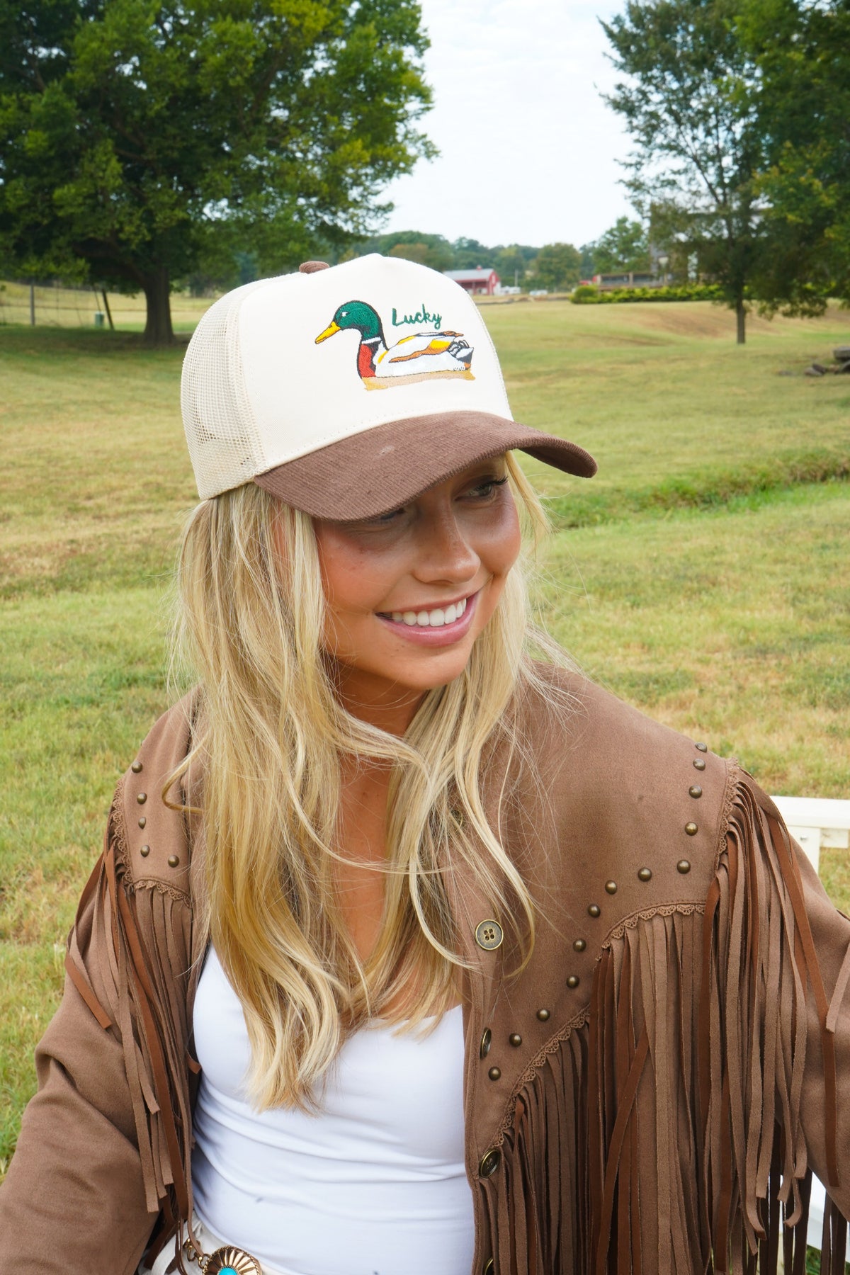 Brown corduroy trucker hat with cream front panel and duck “Lucky” logo.