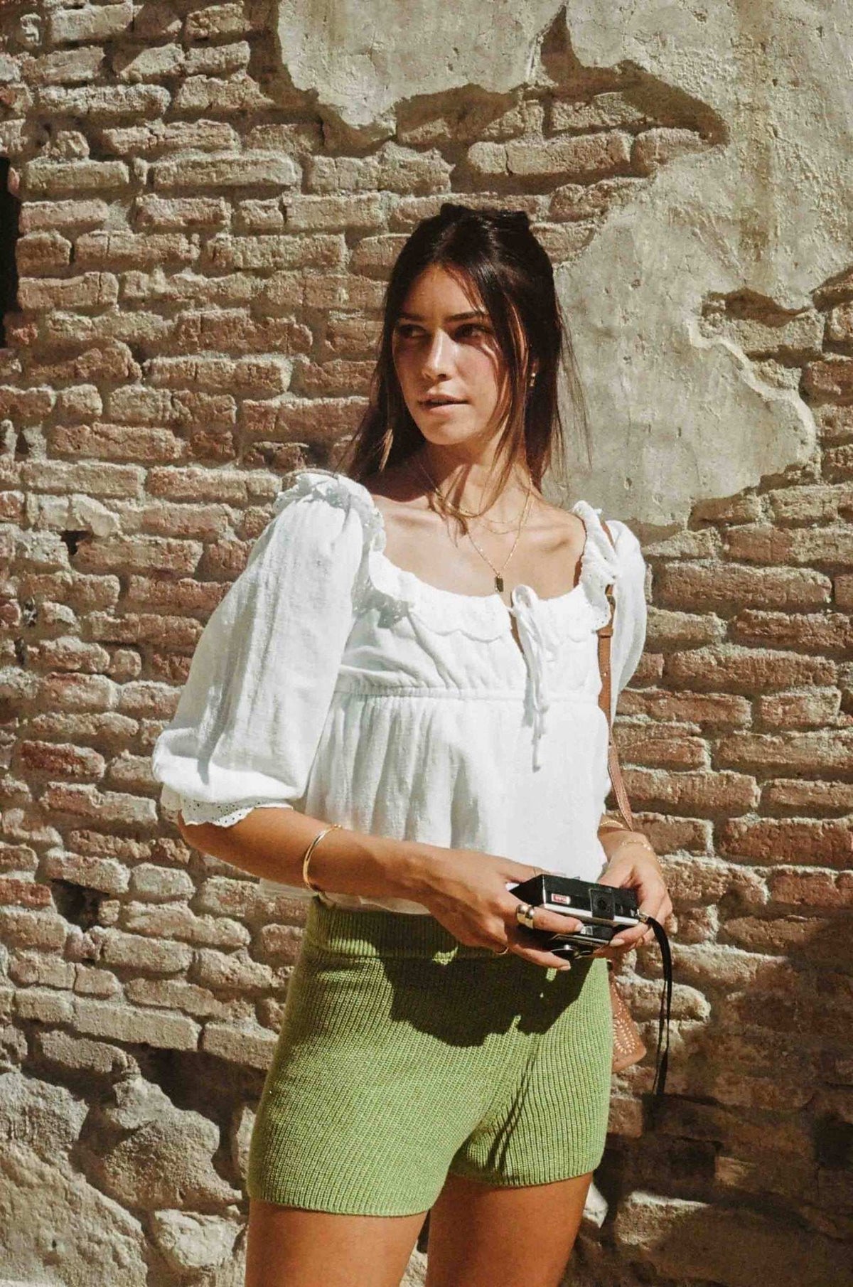 White lace crop blouse with gathered front, square neckline, and shoulder ruffle detail