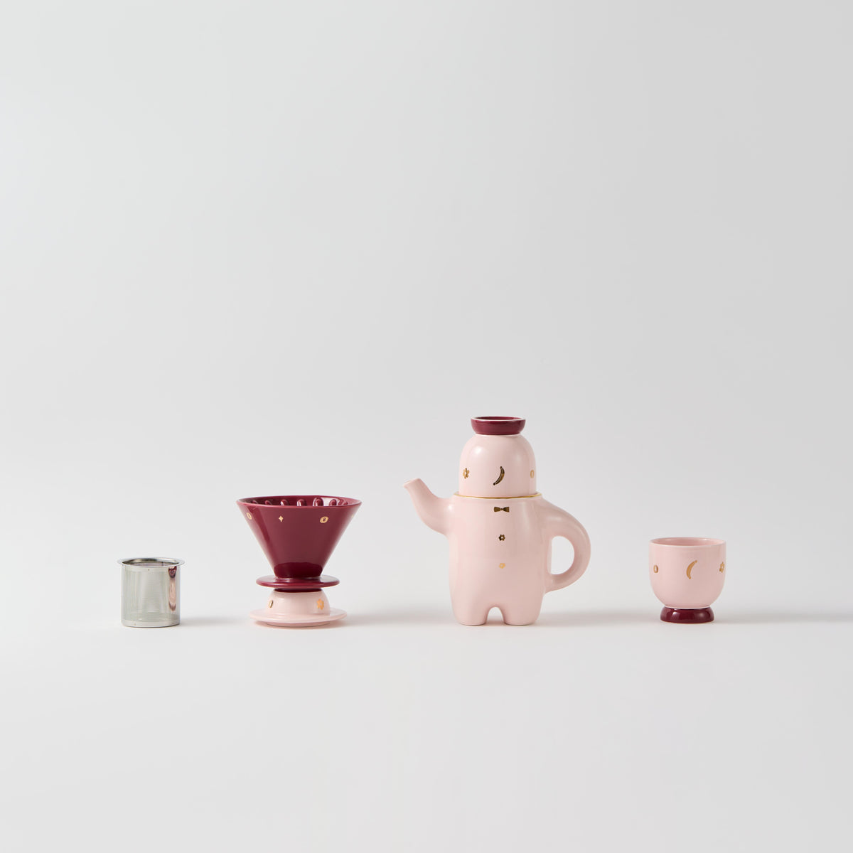 Pink porcelain teapot set with coffee dripper and cups, plus small glass container