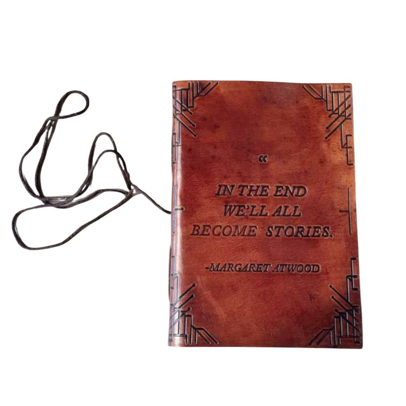 Brown leather journal with embossed corner pattern and Margaret Atwood quote on cover