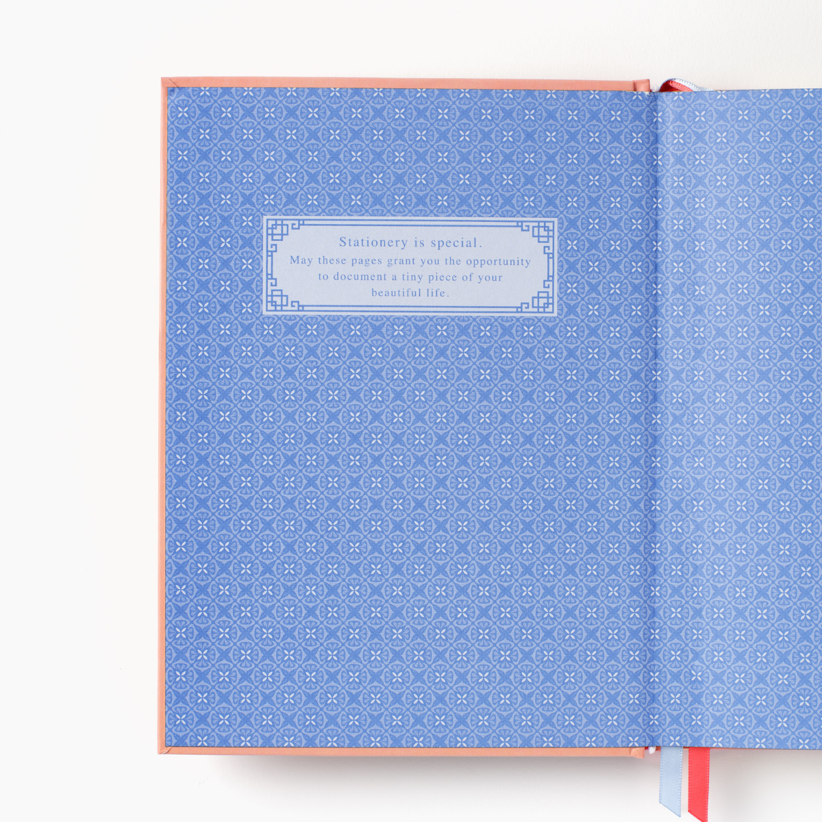 Hardcover notebook interior with blue patterned cover and boxed quote text