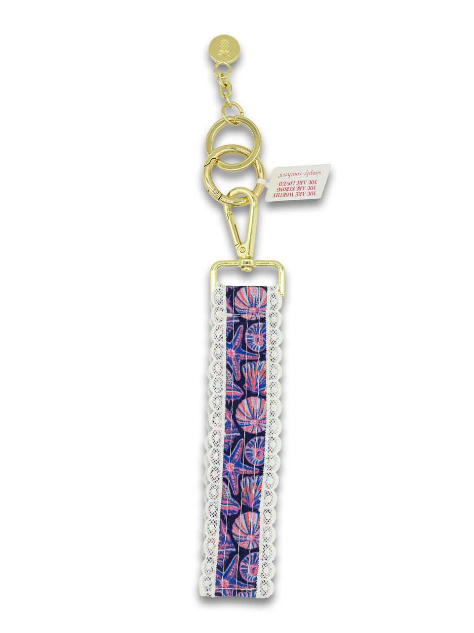 Purple shell lace keyfob with gold chain, purple-blue patterned fabric and white lace trim
