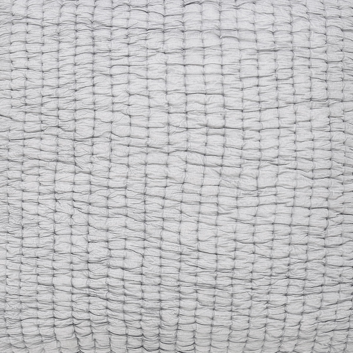 Stone-washed cotton quilt fabric close-up in white with subtle woven grid texture.