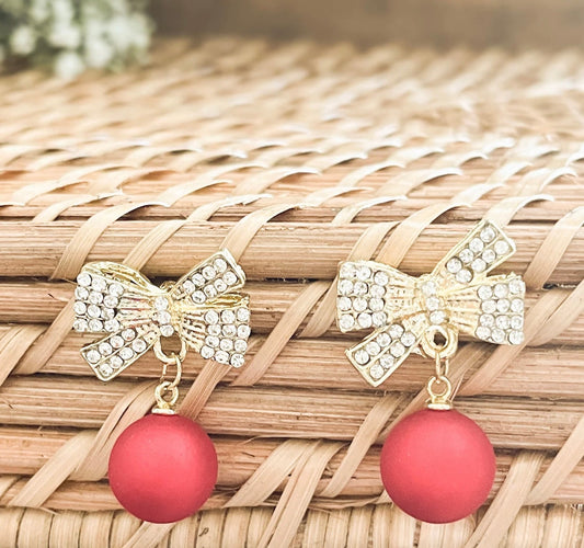 Gold bow Christmas bulb ornaments with red hanging bead drops, rhinestone details