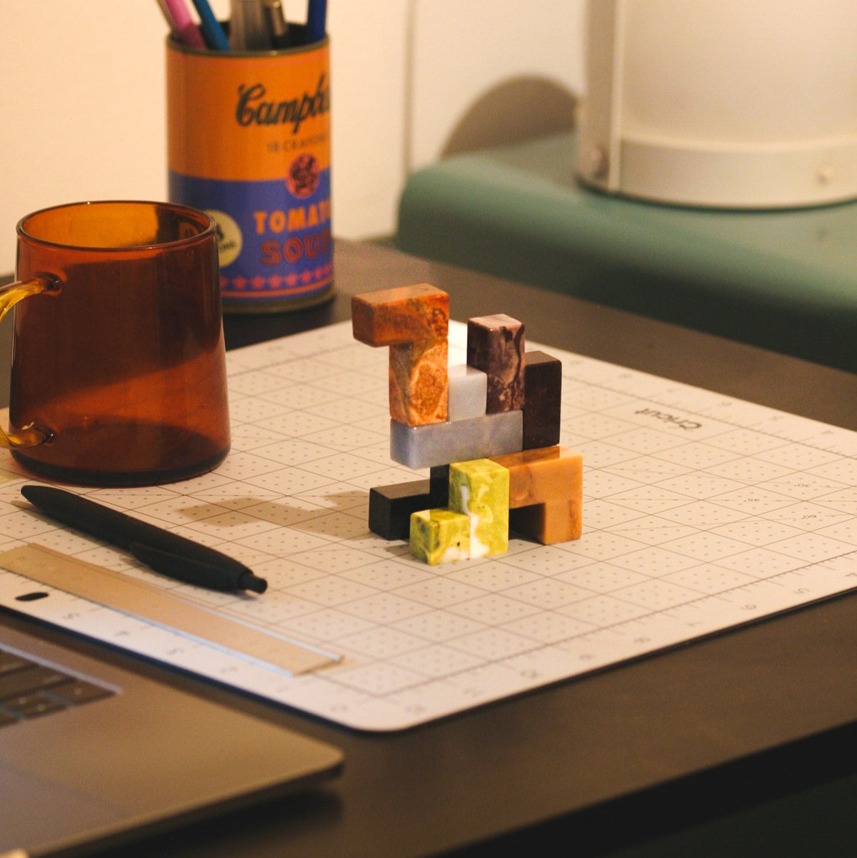 Gemstone Soma cube puzzle showing stacked stone cubes in orange and dark blocks