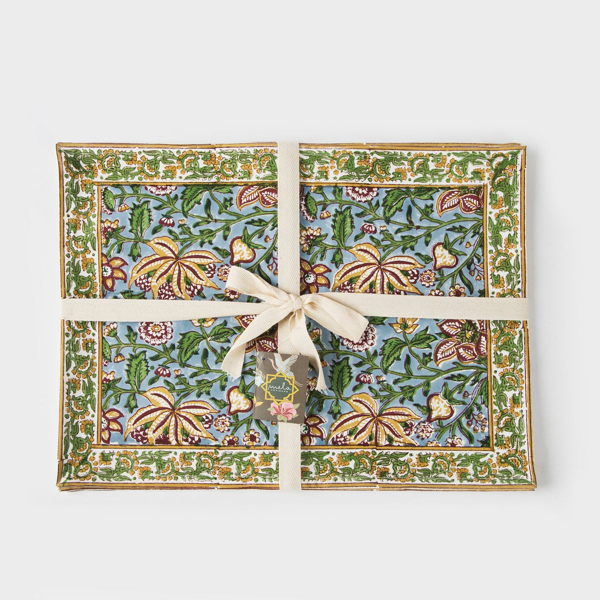 Set of four cotton placemats tied with beige ribbon; green and blue floral print