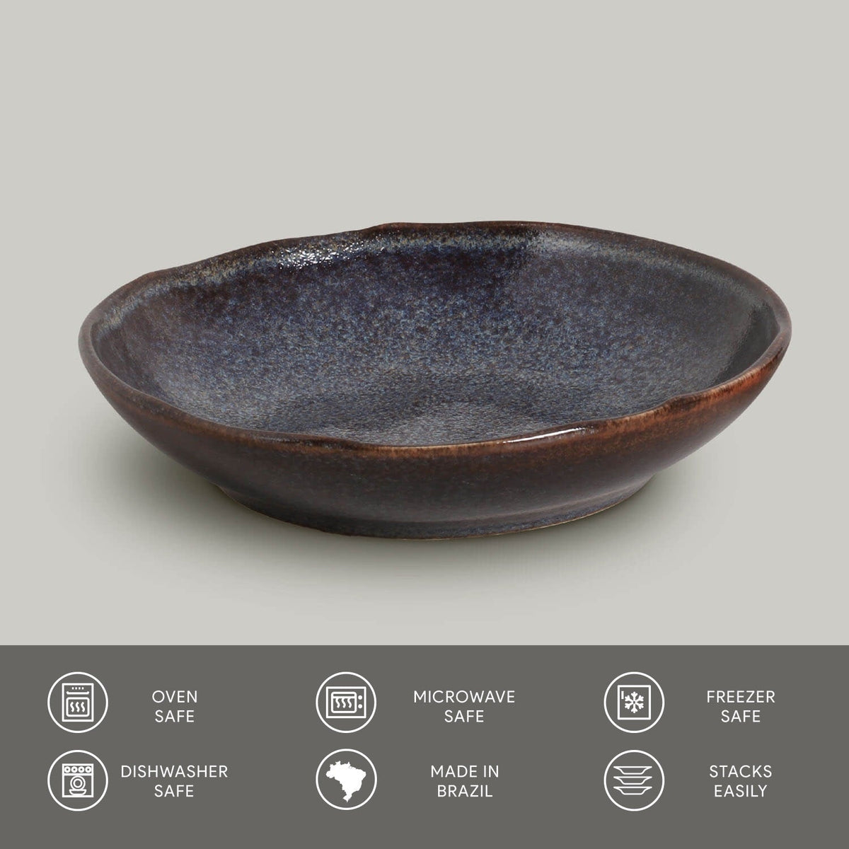Blue-gray ceramic pasta plate with glossy reactive glaze and brown-toned outer rim.