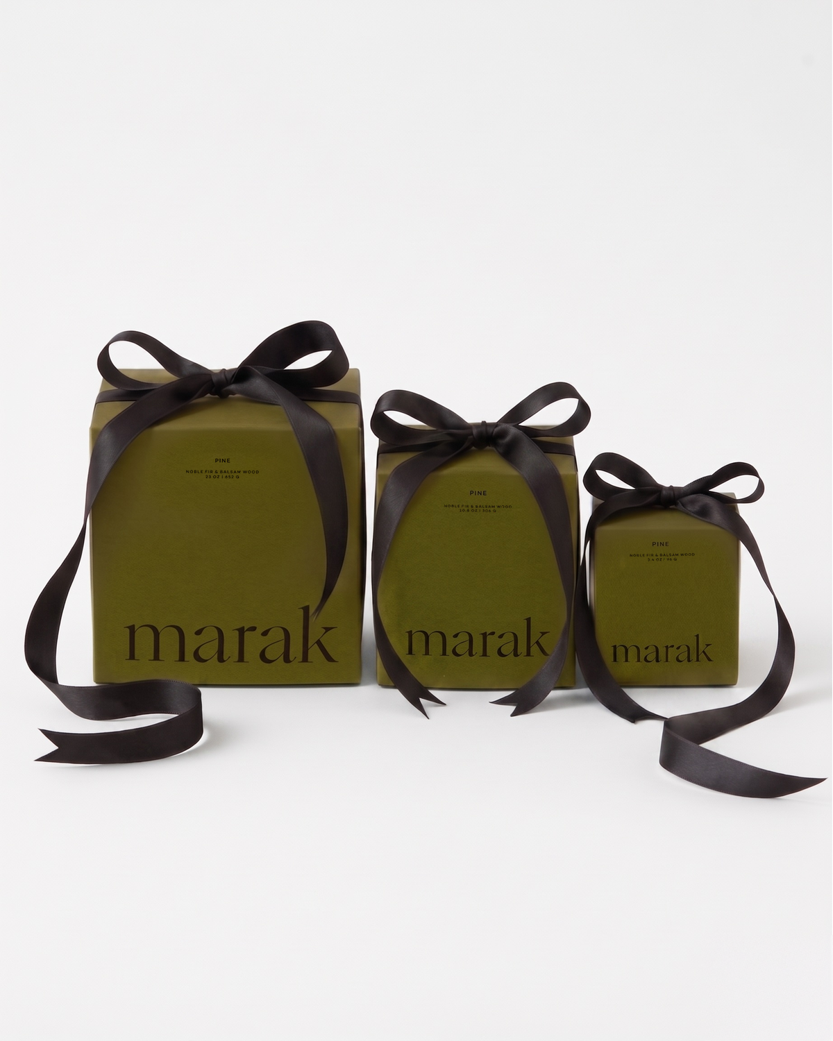 Three green marak gift bags with black ribbon
