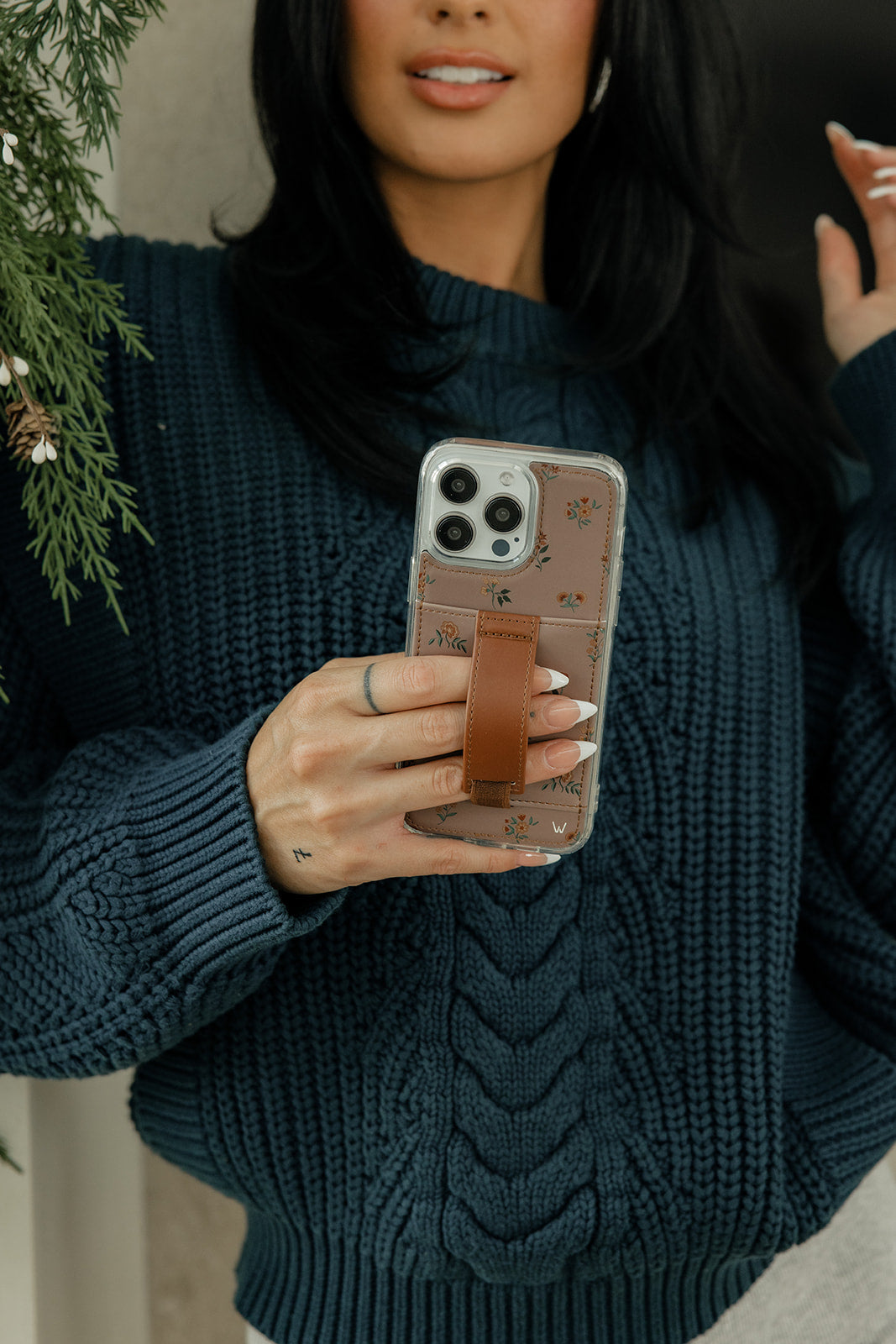 Mauve Meadow phone case with floral pattern on a phone, held up to camera